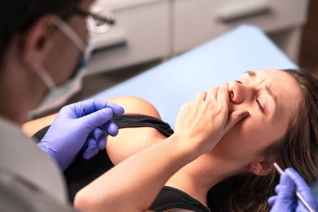 Patient experiencing pain while receiving dental care